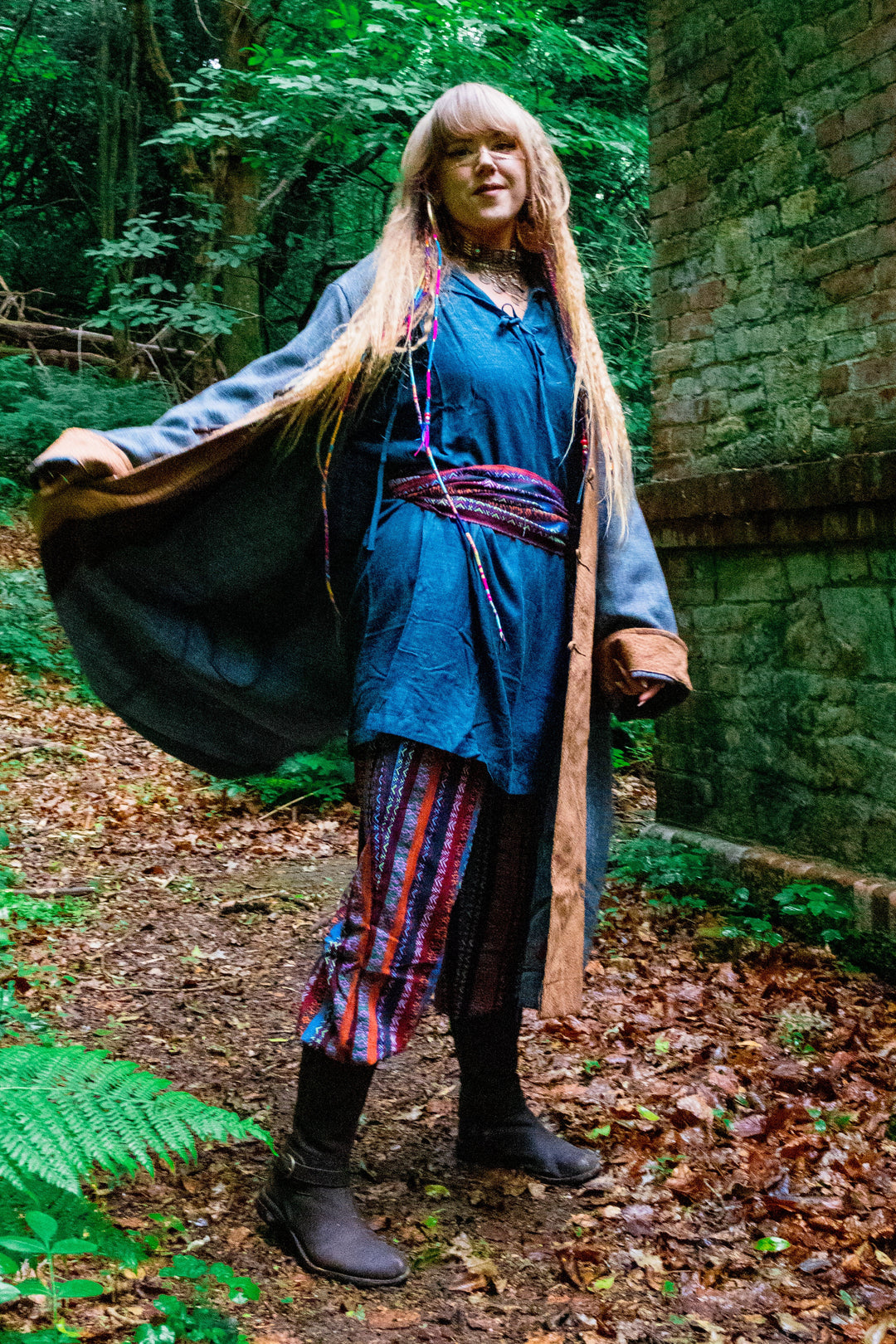 Medieval LARP costume side view in forest, robe flowing, colourful pants.