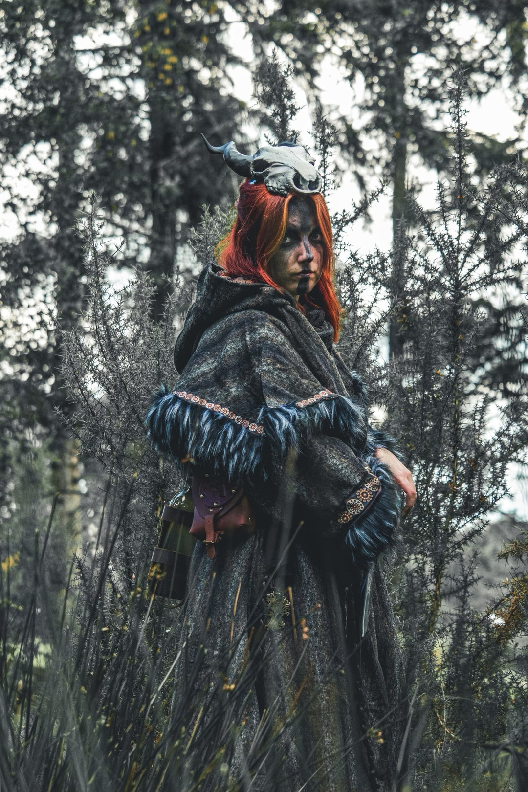 Arcane Shaman LARP outfit with grey tunic, blue-edged hood, and patterned sash.