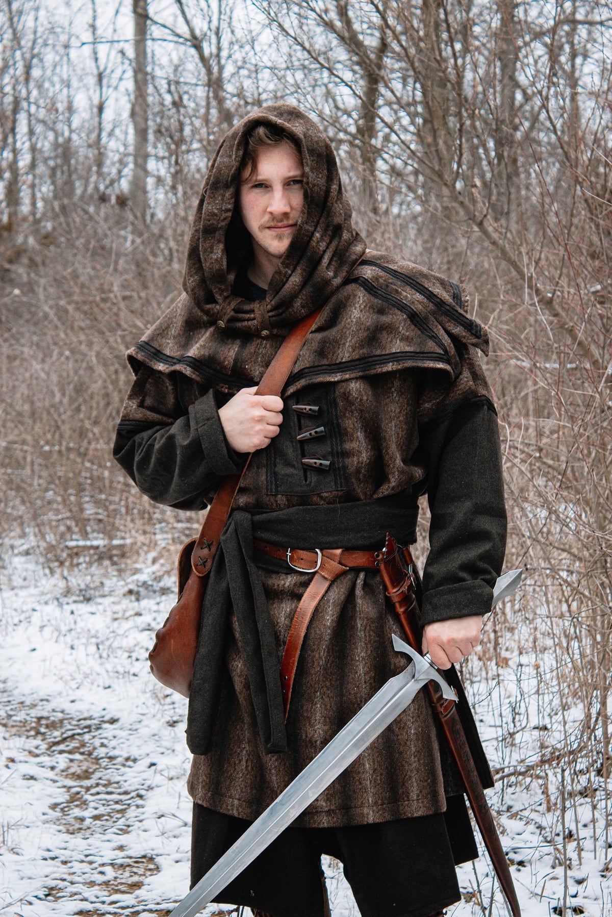 Brown mohair snood hood for medieval LARP, front view in snowy forest.