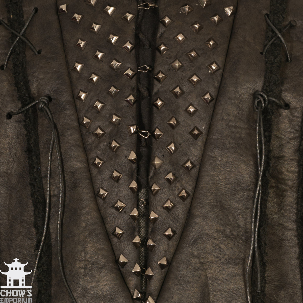 Close-up of studded medieval faux leather LARP jacket with lace details.