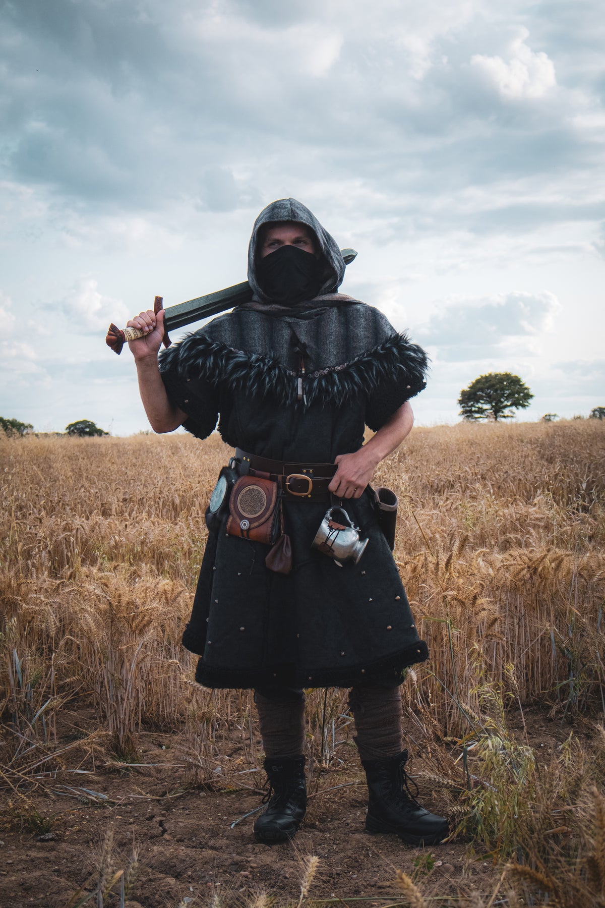 Medieval LARP costume front view featuring a black faux leather tunic and wool wrap around hood.