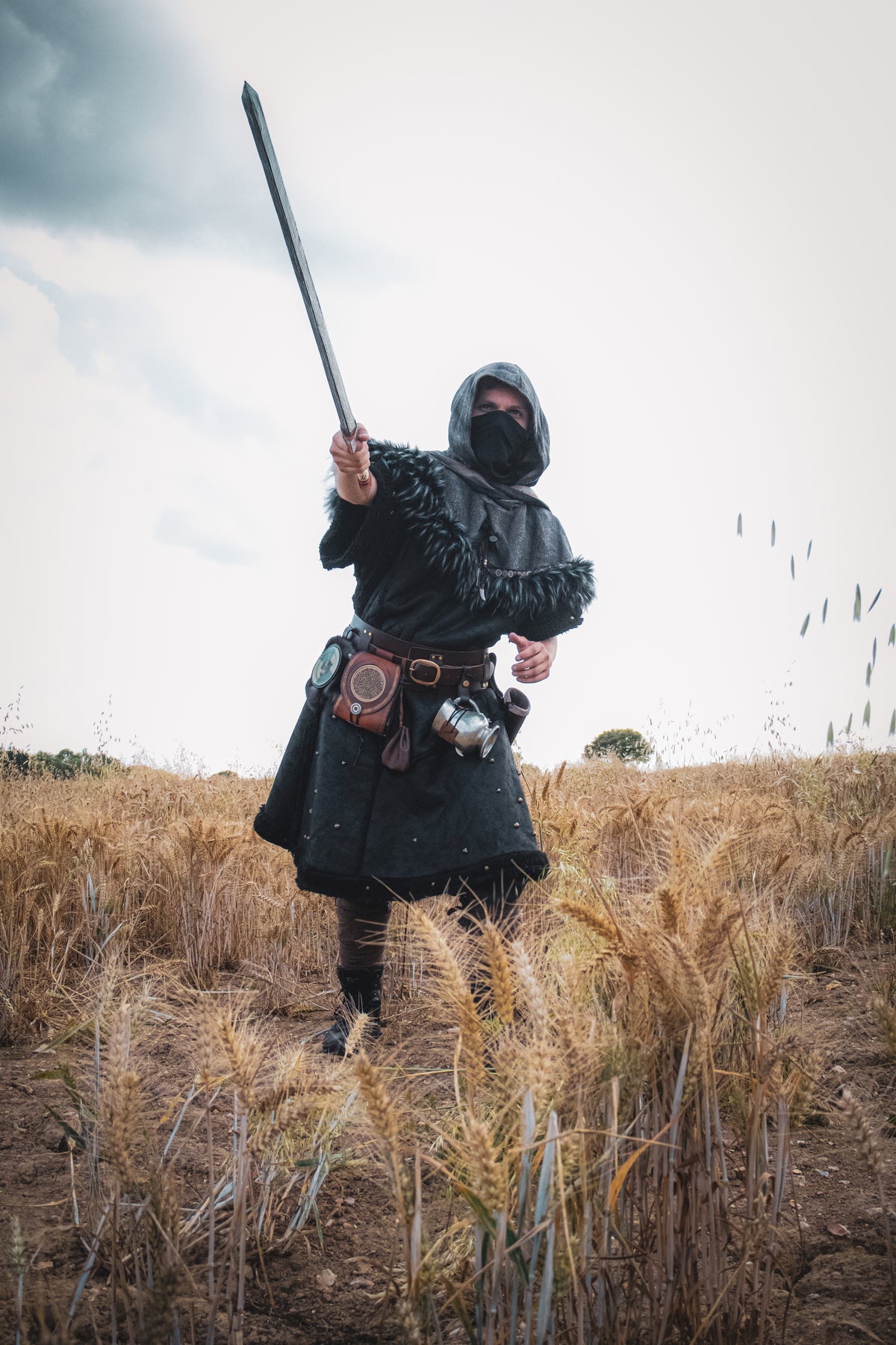 Barbarian LARP armour set with faux leather tunic and mohair hood in action stance.