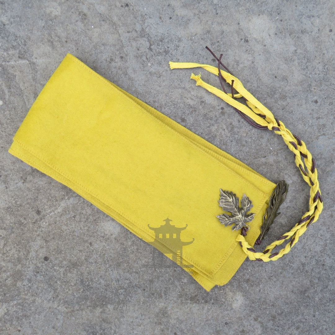 Folded ochre wool sash showing the woven texture