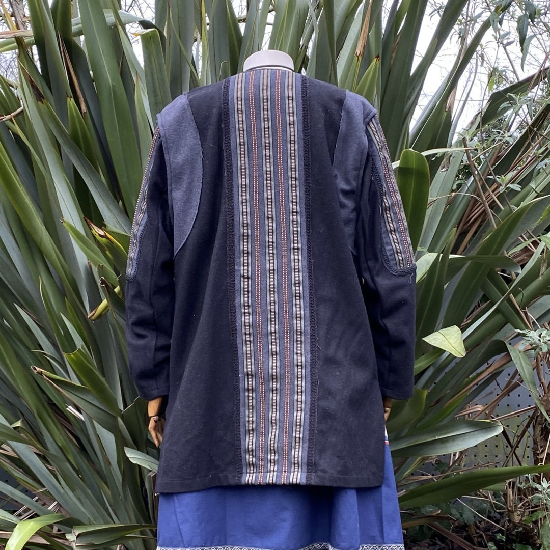 Back view of LARP tunic with striped panel, blue skirt visible.