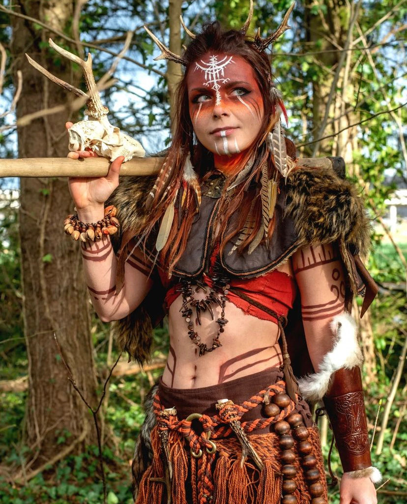 Brown ornate faux leather LARP hood with fur trim in woodland setting.