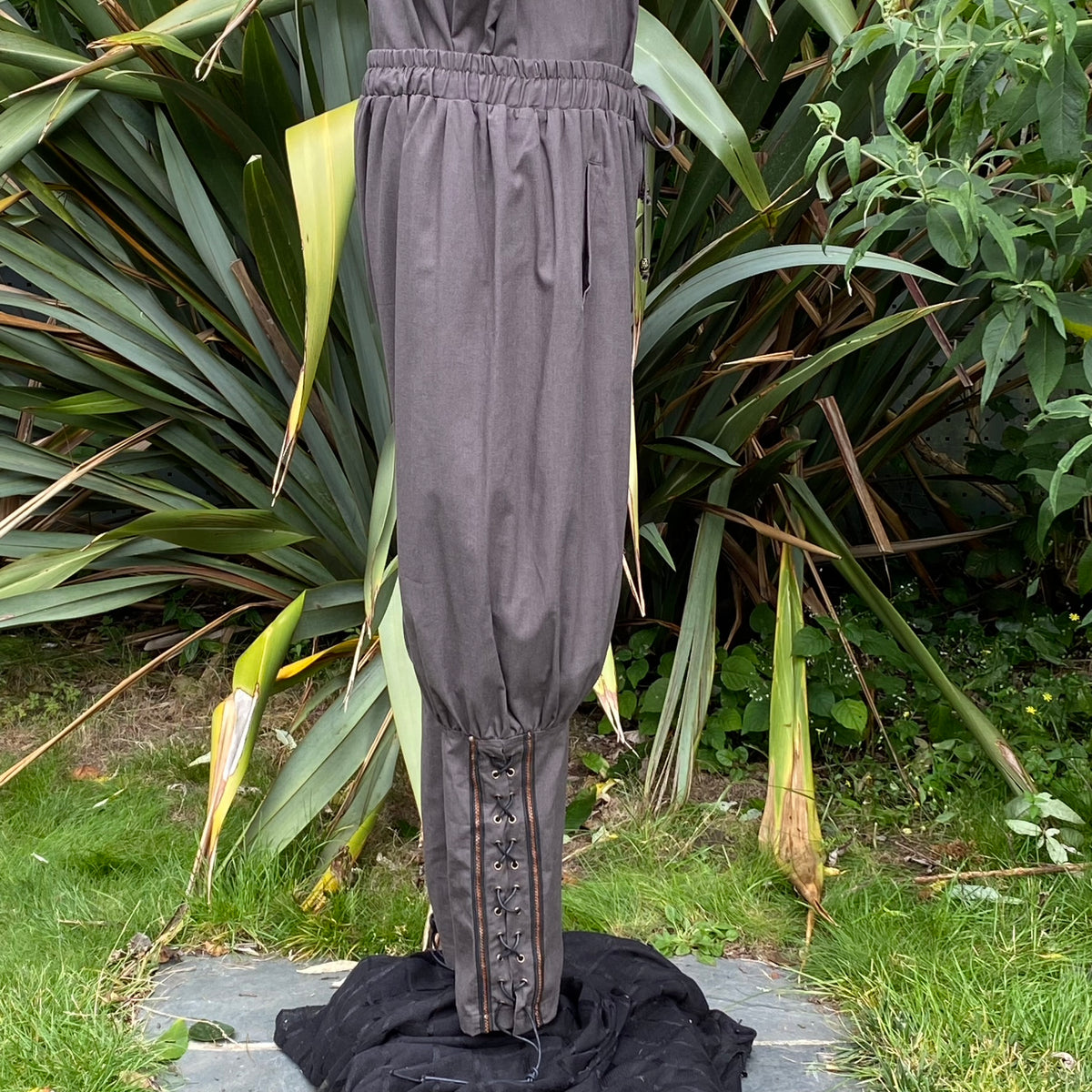Black medieval LARP pants with lace-up details, side view.
