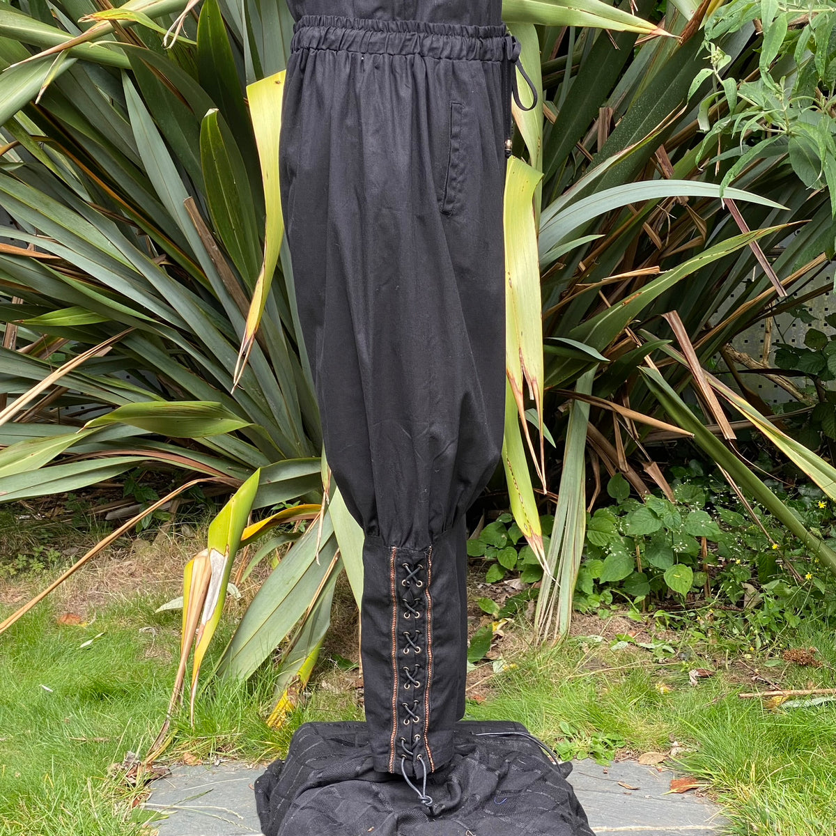 Black cotton Viking pants with ankle lacing for medieval LARP.