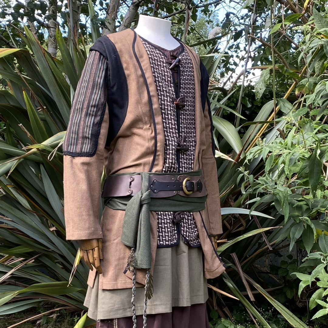 LARP alchemist outfit with green sash, leather belt, and earthy tones.