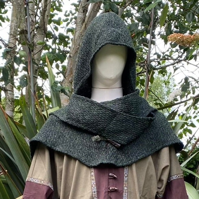 Medieval LARP outfit, forest backdrop, close-up of green hood and sash.