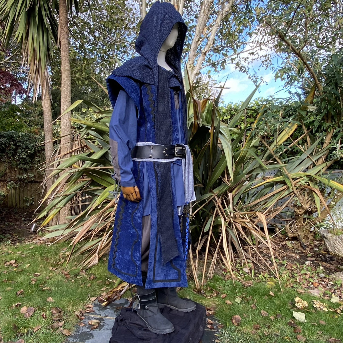 LARP costume side view with blue hooded coat, leather belt.
