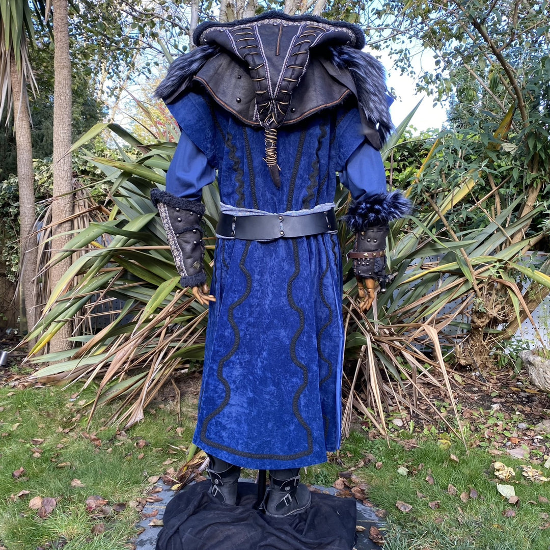 Rear view of LARP medieval mage set with blue tunic and fur-trimmed vambraces.