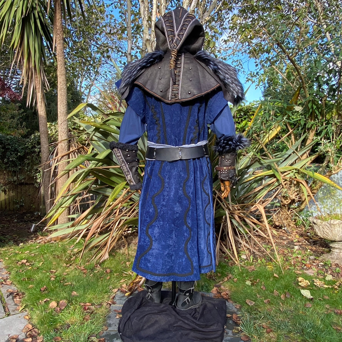 Blue velvet medieval LARP tunic set with black hood and vambraces, rear view.