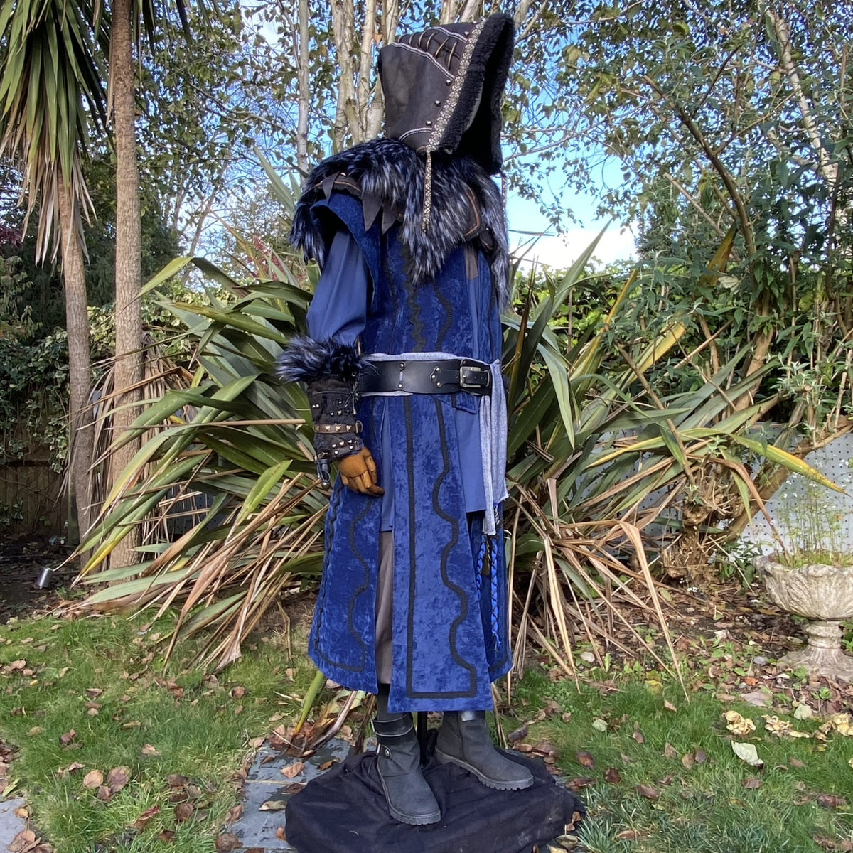 Medieval LARP costume side view, featuring a blue suede-effect panel waistcoat, black.