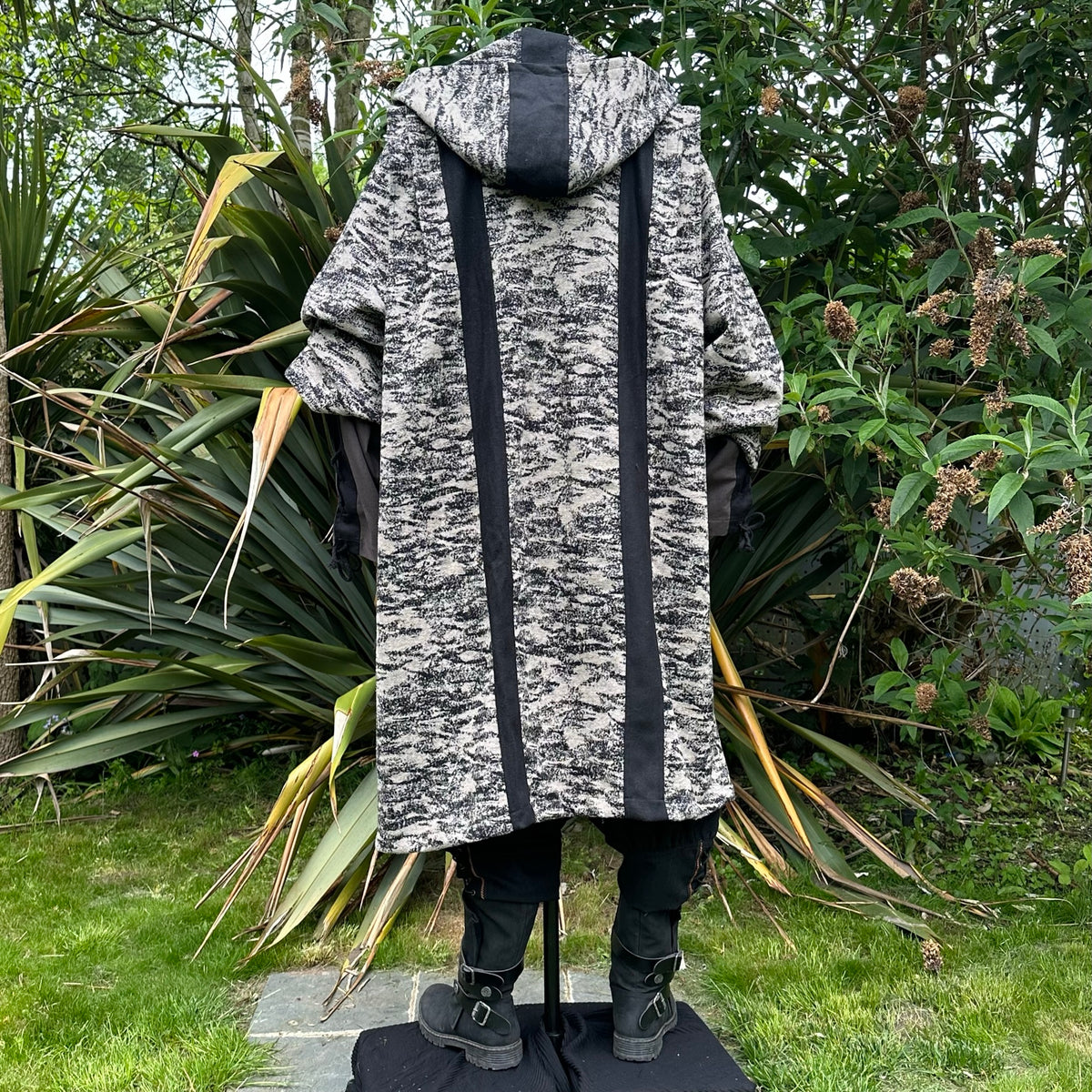 Rear view of medieval LARP robe with ornate striped hood.