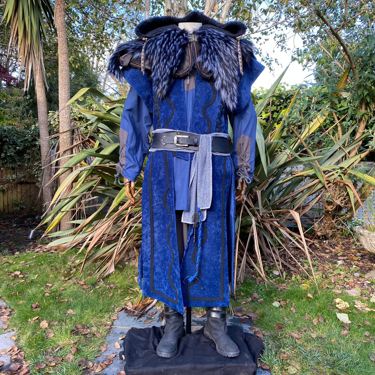 LARP set with blue tunic, ornate hood, waistcoat, and sash.