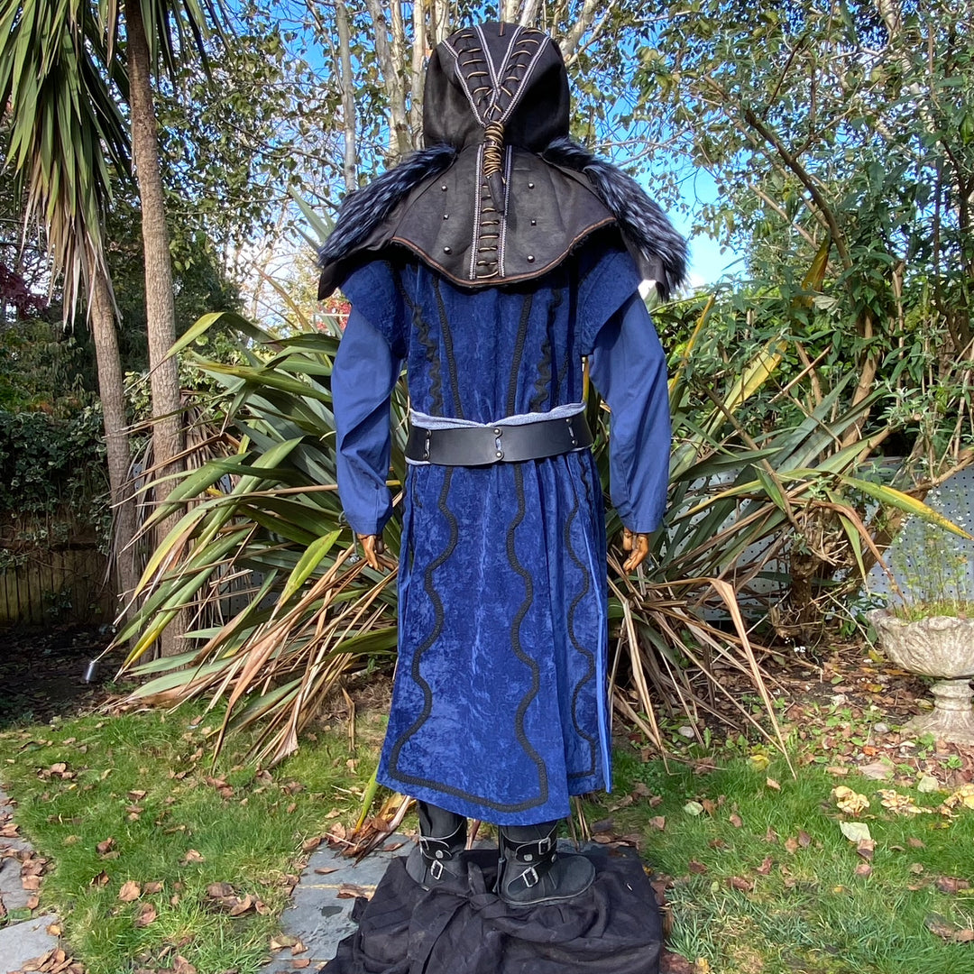 Back view of blue medieval LARP costume with black ornate hood and fur trim.
