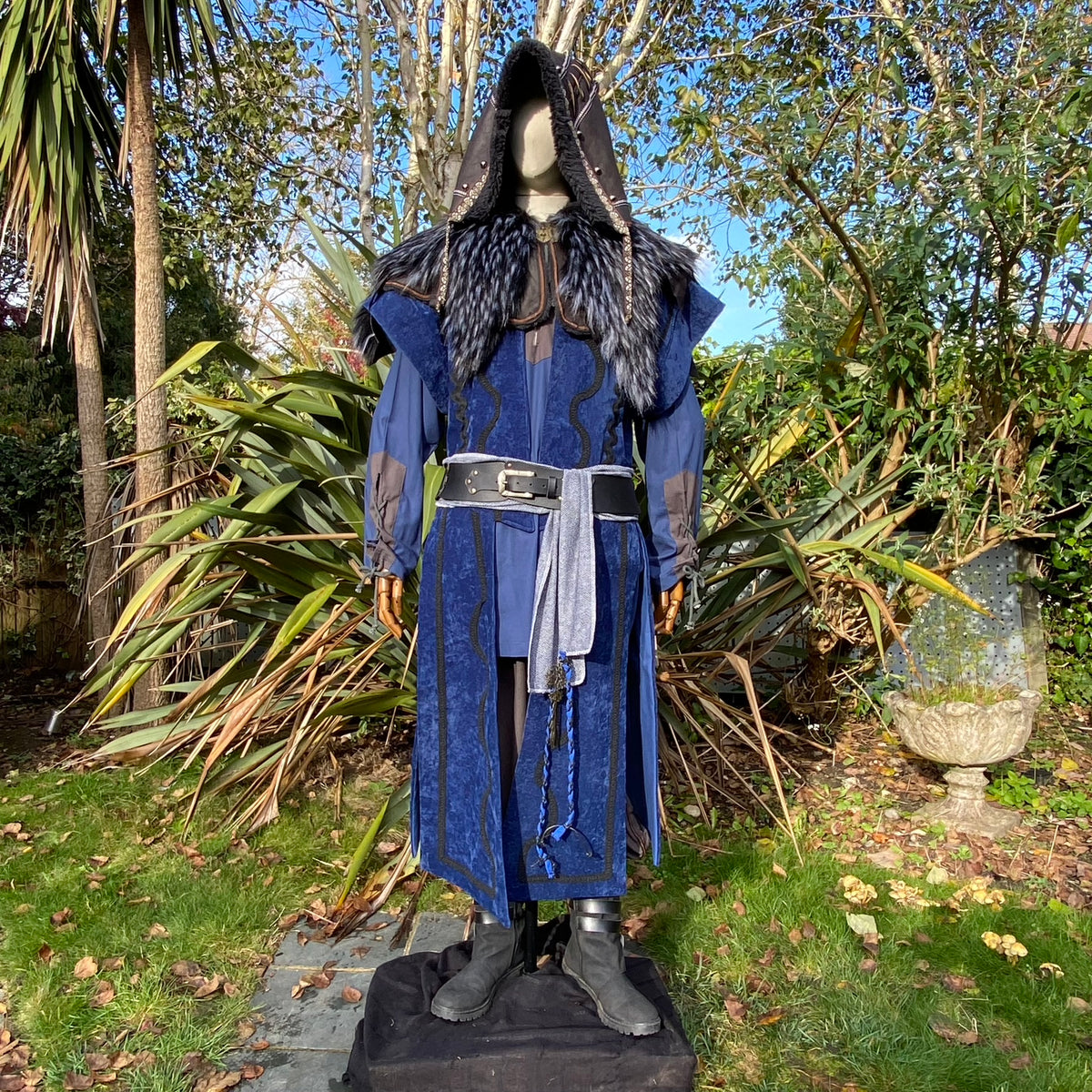 Mannequin in blue medieval LARP outfit with fur-trimmed hood.