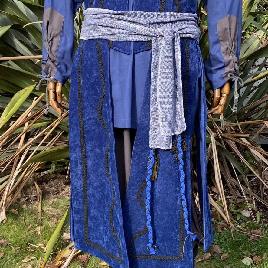Close-up of blue medieval LARP sash and waistcoat with braided details.