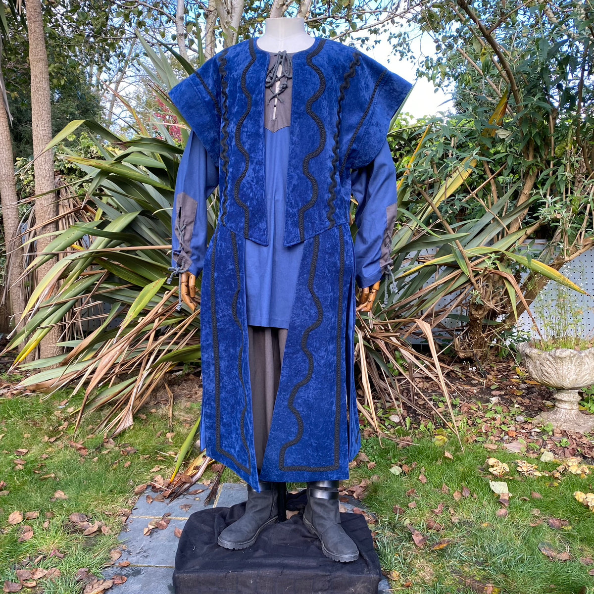 LARP medieval outfit with blue suede robe, garden background view.