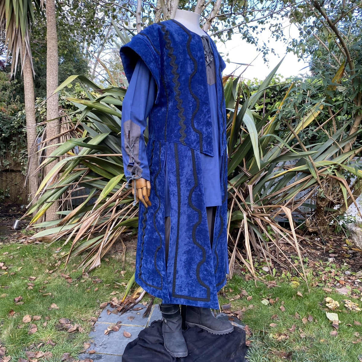 LARP medieval outfit side view; blue suede waistcoat, two-tone shirt.