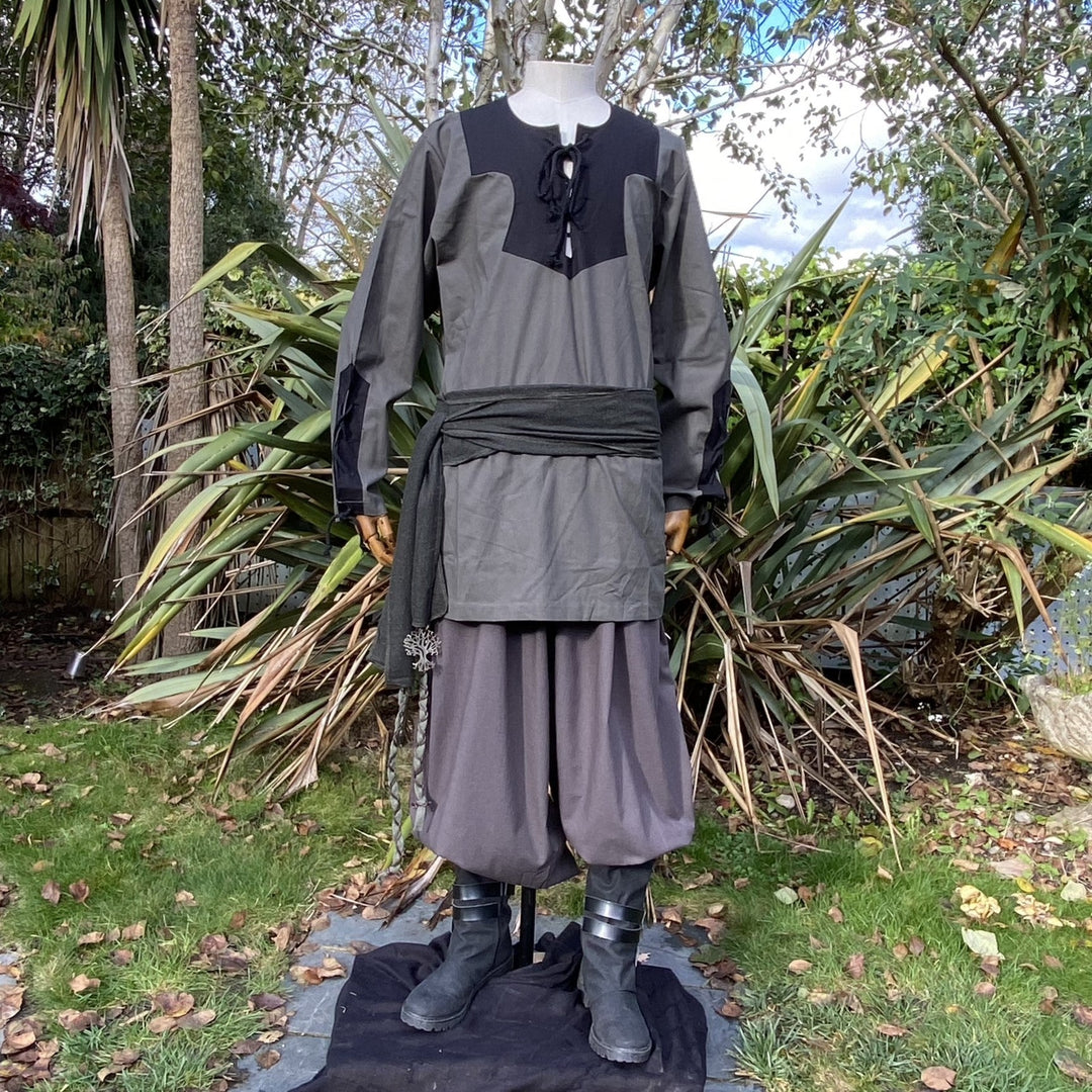 Medieval LARP outfit on mannequin with green sash.