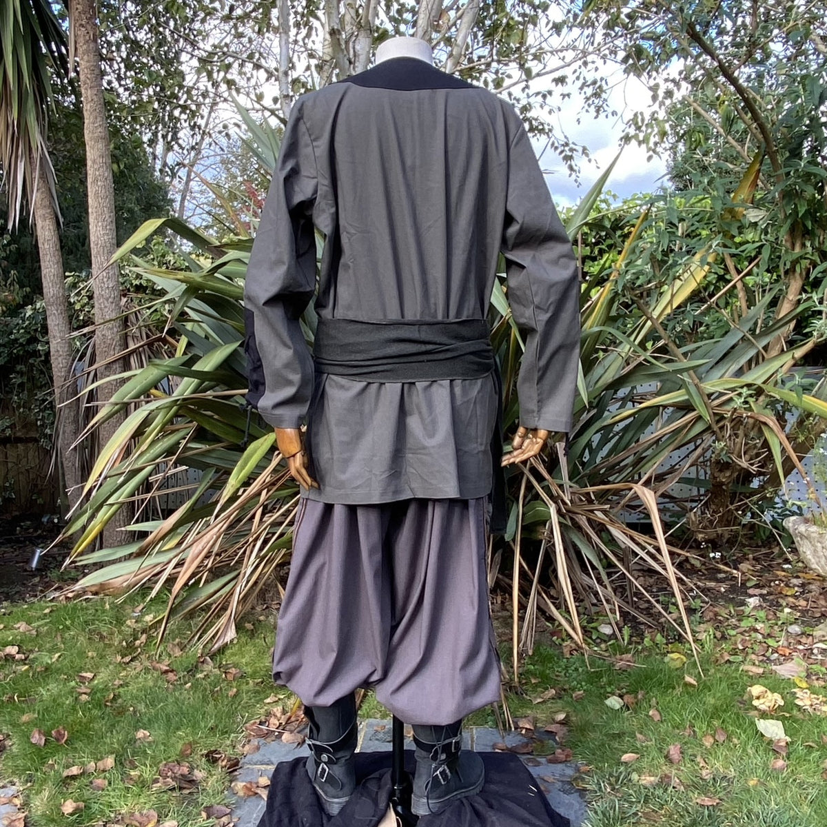 Back view of green and black LARP outfit with sash.