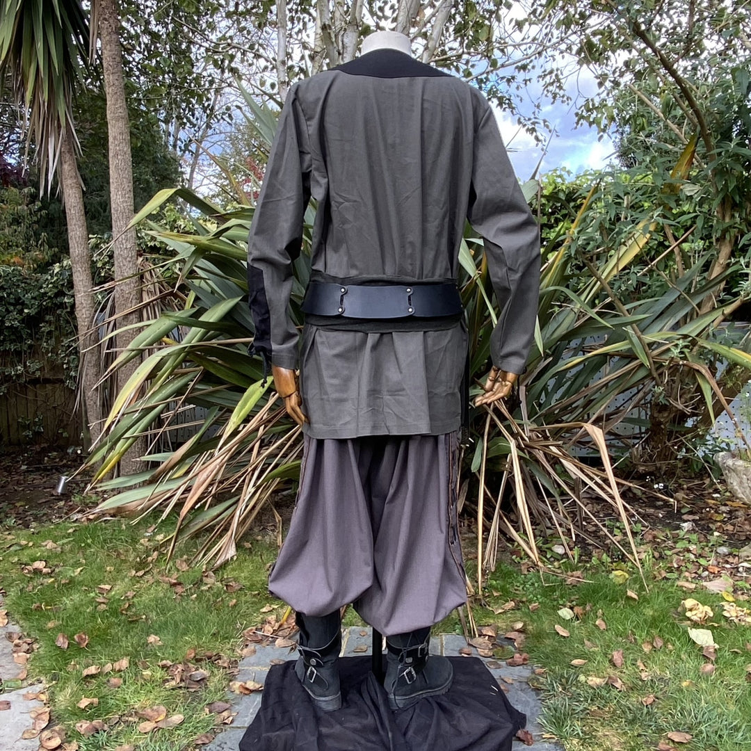 Back view of LARP outfit with green shirt, black sash, and flowing pants.