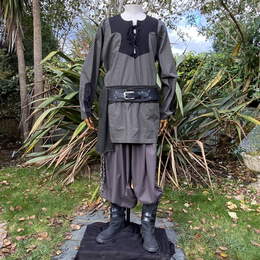 Medieval LARP outfit on mannequin, outdoor garden view, green-black ensemble.
