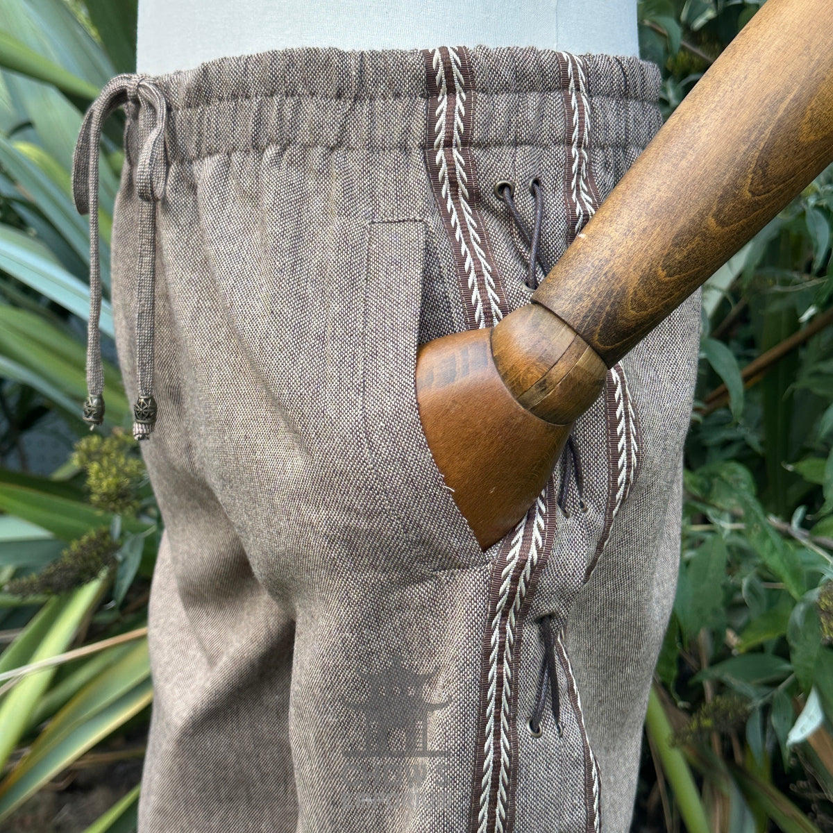 Brown LARP medieval pants with drawstring, side view, natural fabric.