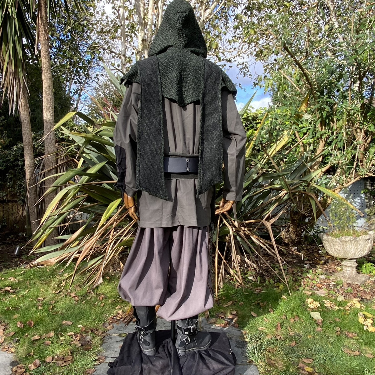 Rear view: LARP medieval outfit with green hood, black shirt.