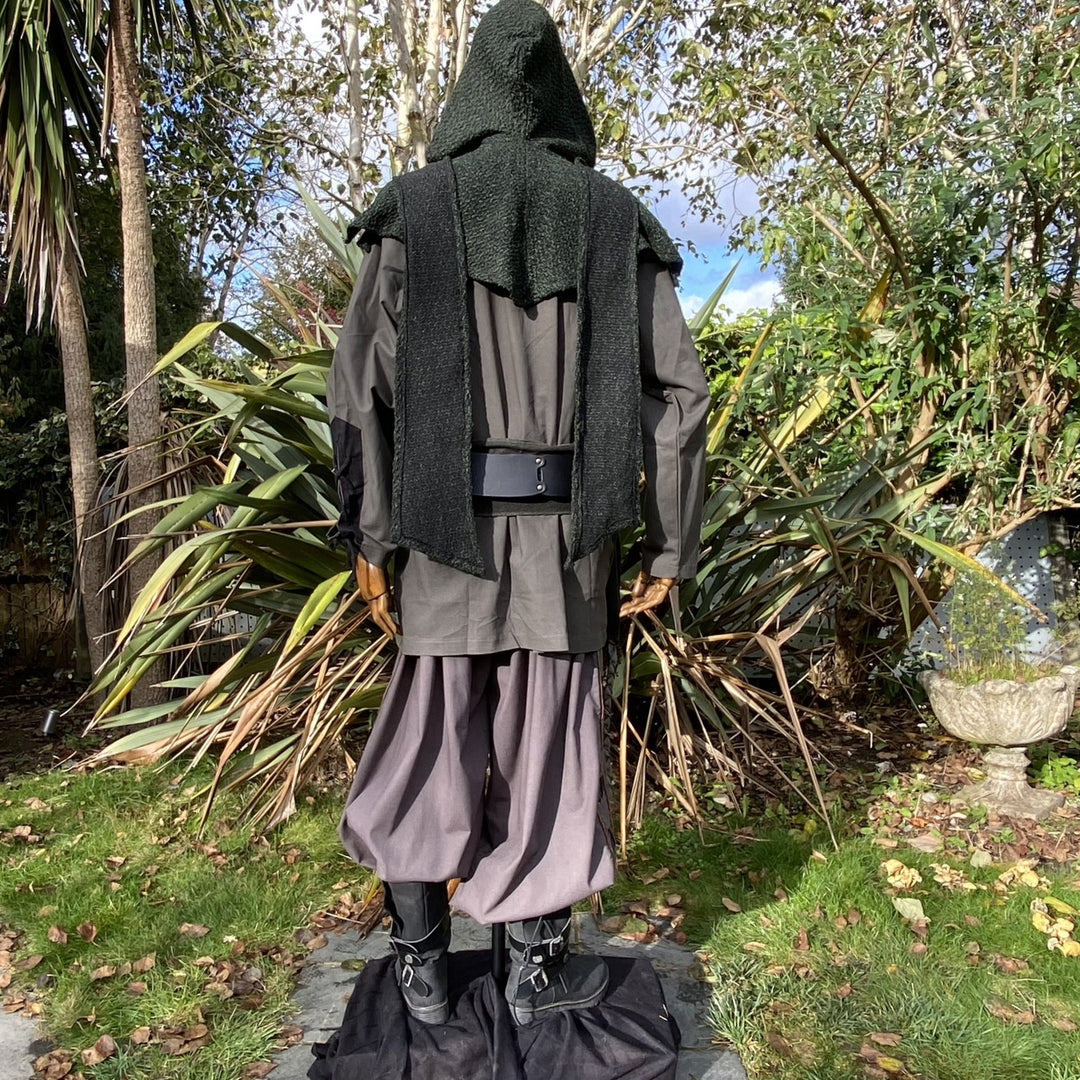 Rear view: LARP medieval outfit with green hood, black shirt.