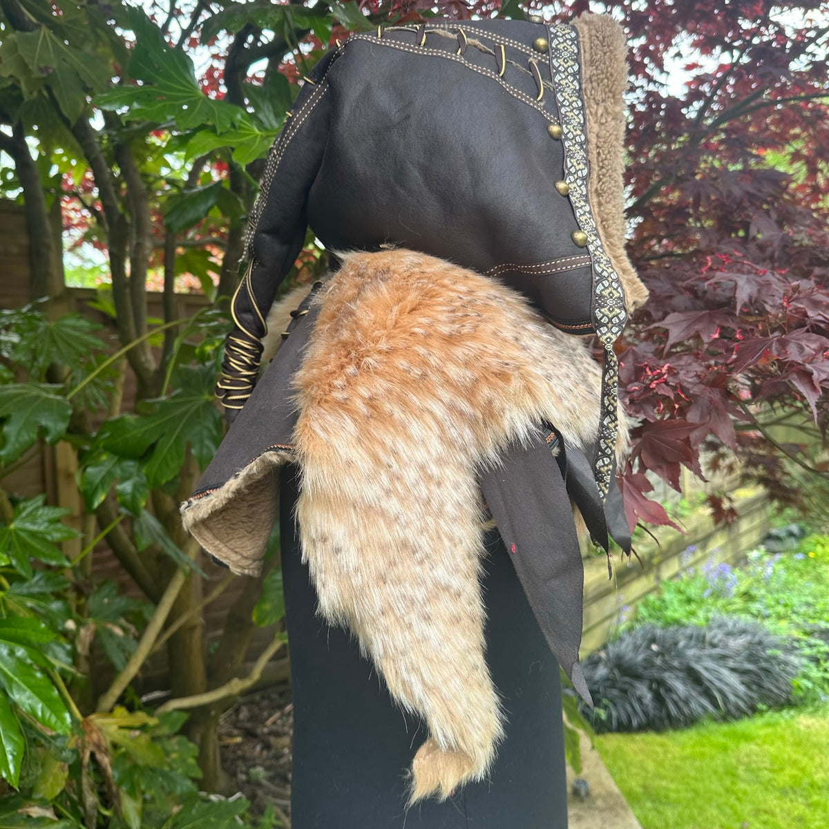 Back view of ornate medieval LARP hood with faux fur tail detail.