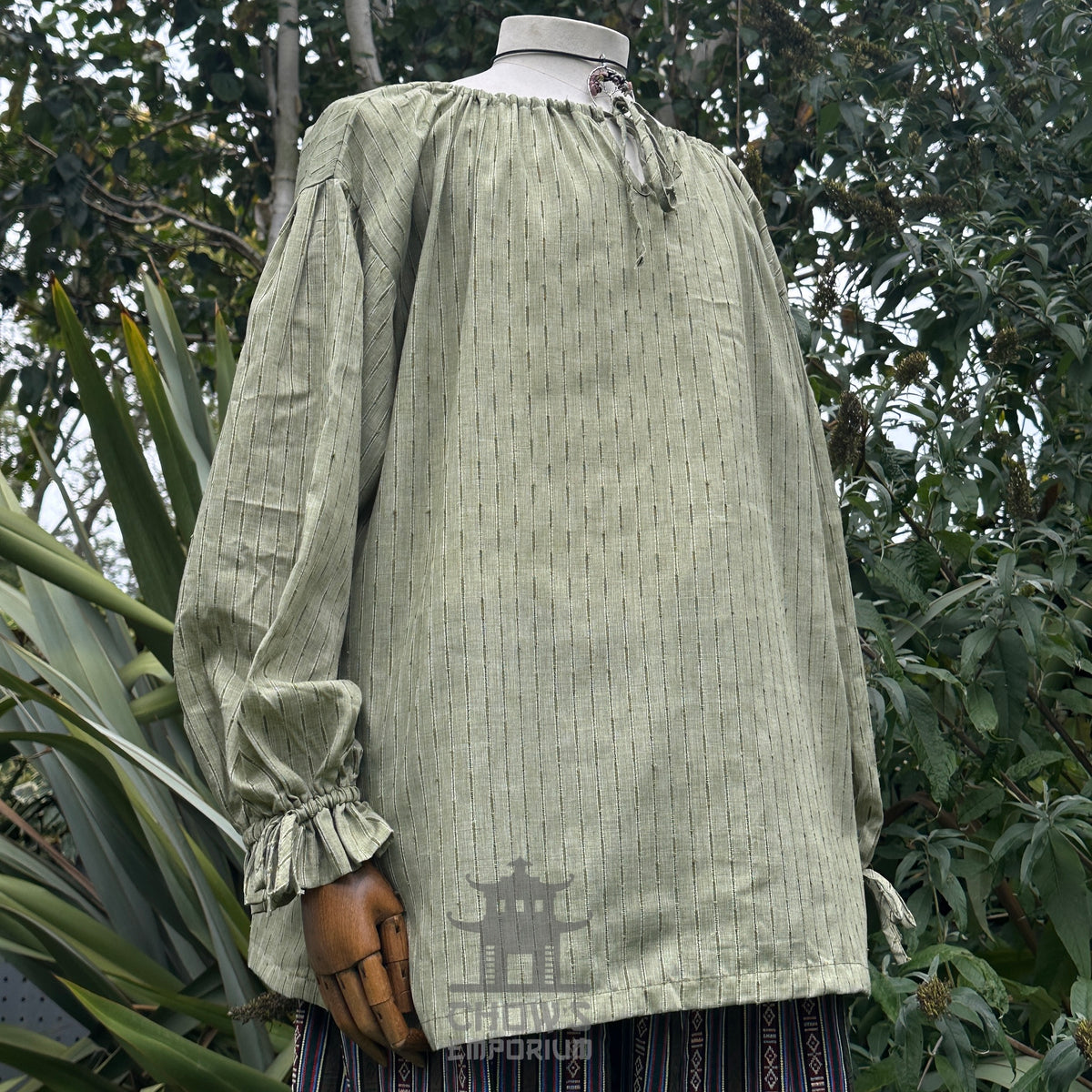 Green medieval LARP shirt, round neck, long sleeves, cotton, side view.