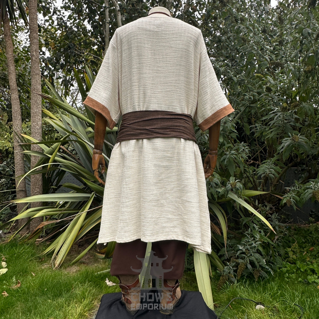 Medieval LARP outfit back view, featuring a white and brown shirt, trousers, and sash.