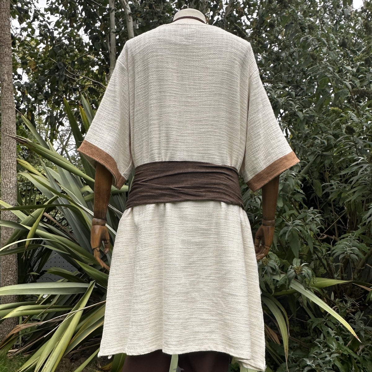 Rear view of cream tunic with brown trim and sash for LARP events.