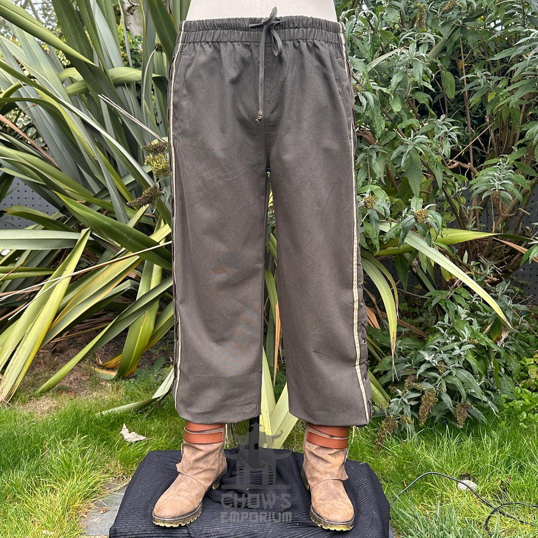 Front view of green and grey cotton medieval straight-leg LARP pants with side braiding detail.