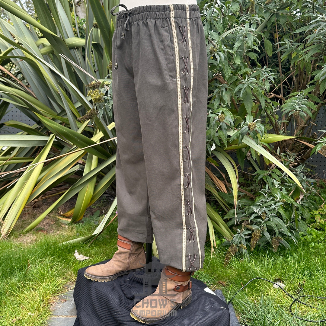 Angled front view of grey cotton medieval trousers with adjustable drawstring waist.