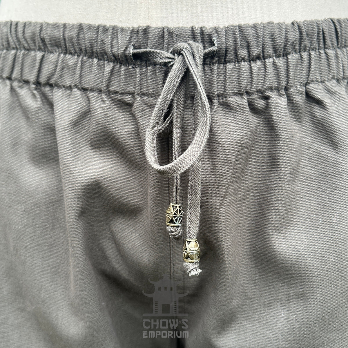 Detail view of waistband with cord tie and elasticated fit for comfort and adjustability.