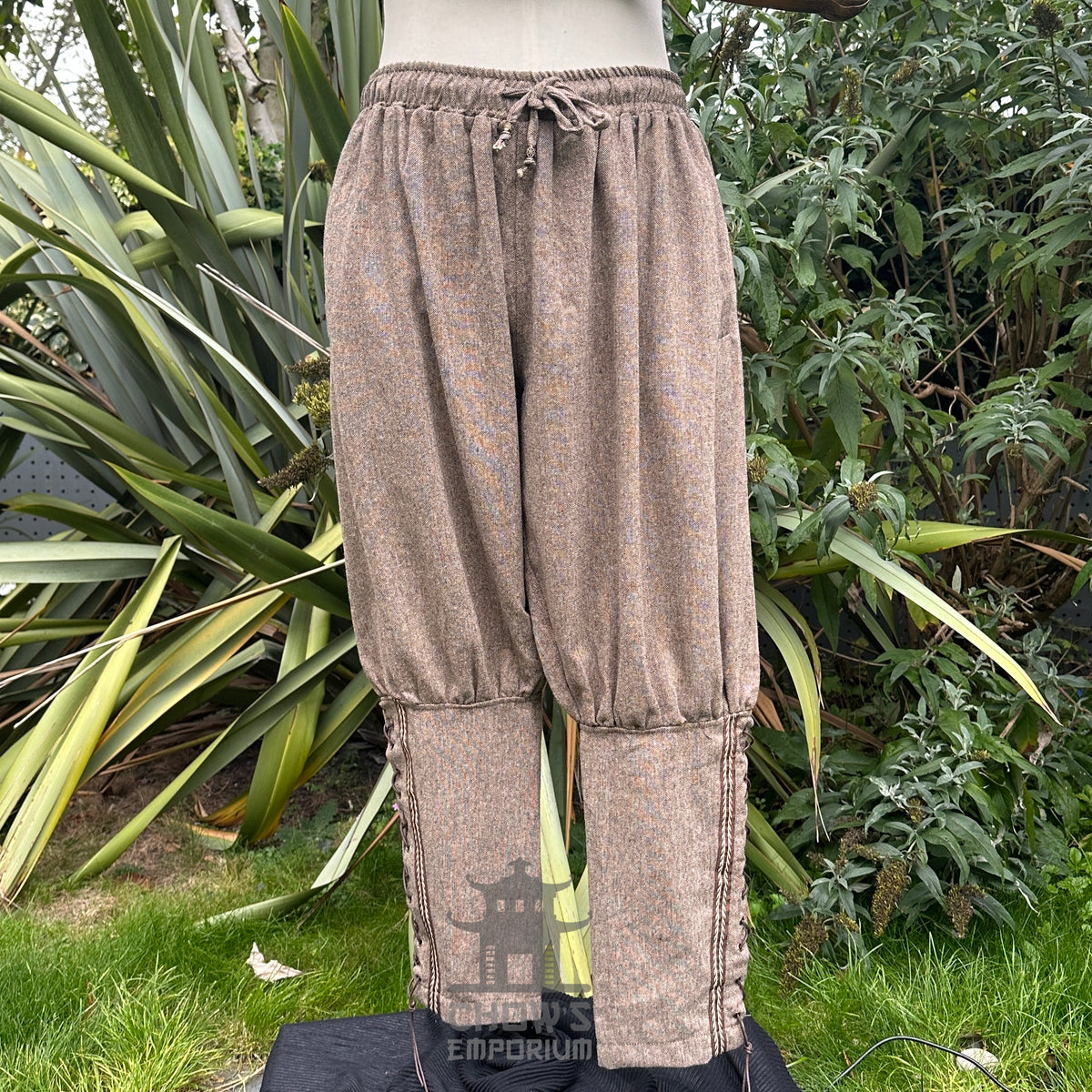 medieval brown wool trousers with braiding trim.