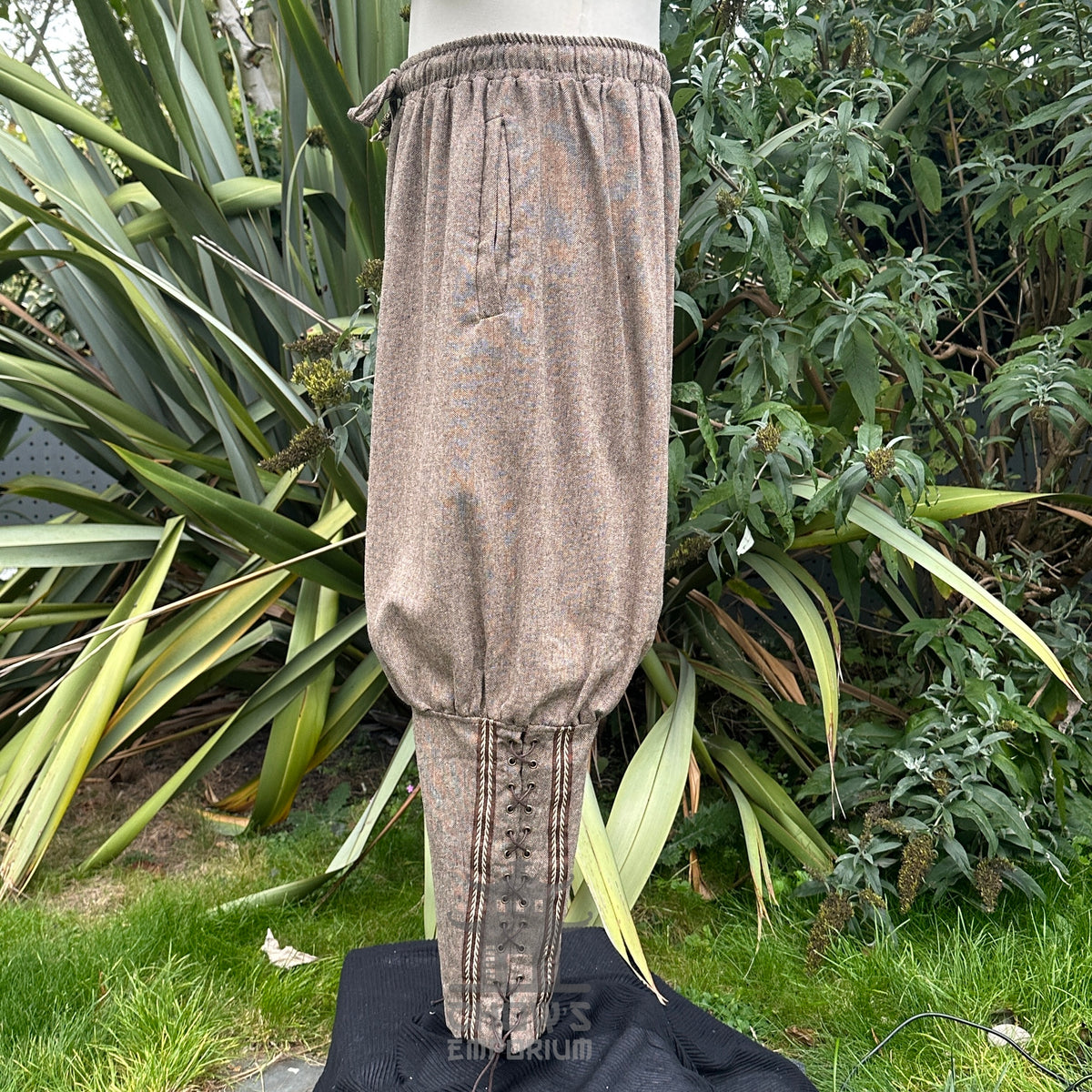 Viking style trousers in brown wool with braiding.