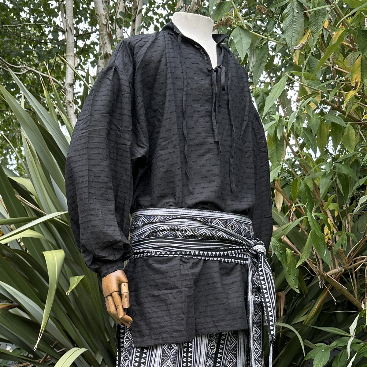Black textured medieval LARP shirt with detailed waist sash.