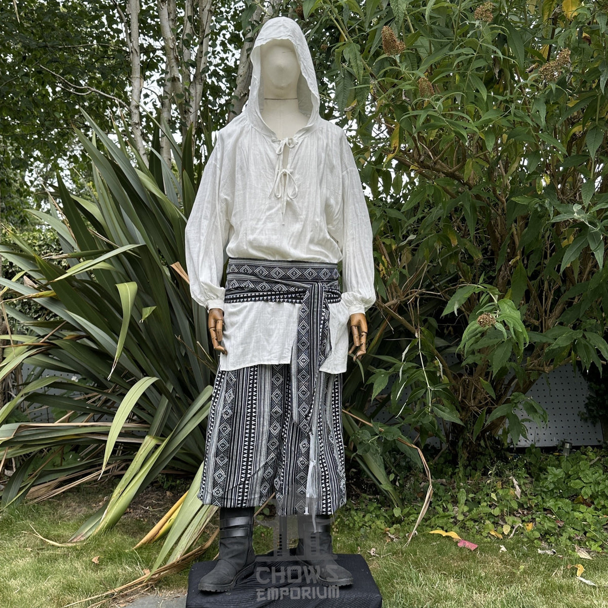 Medieval LARP outfit front view, featuring a white hooded shirt, black and white trousers and sash.