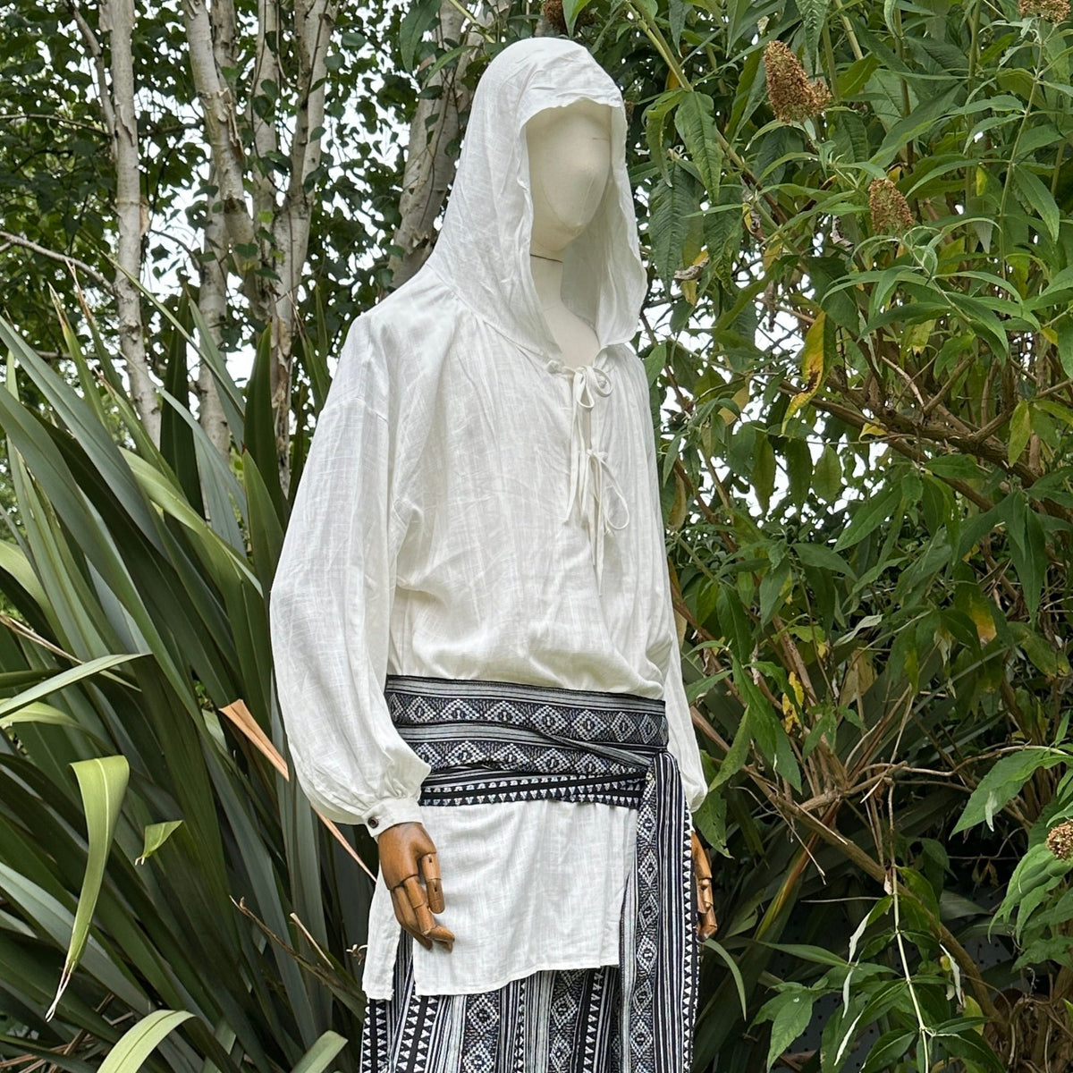 White medieval LARP shirt with hood, side view, styled with decorative sash.