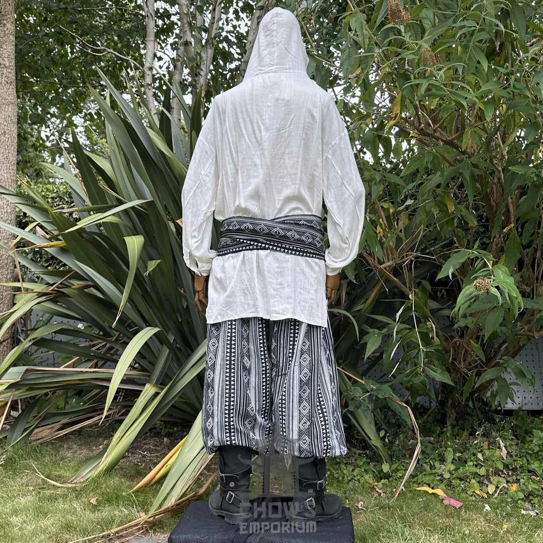 Medieval LARP outfit back view, featuring a white hooded shirt, black and white trousers and sash.