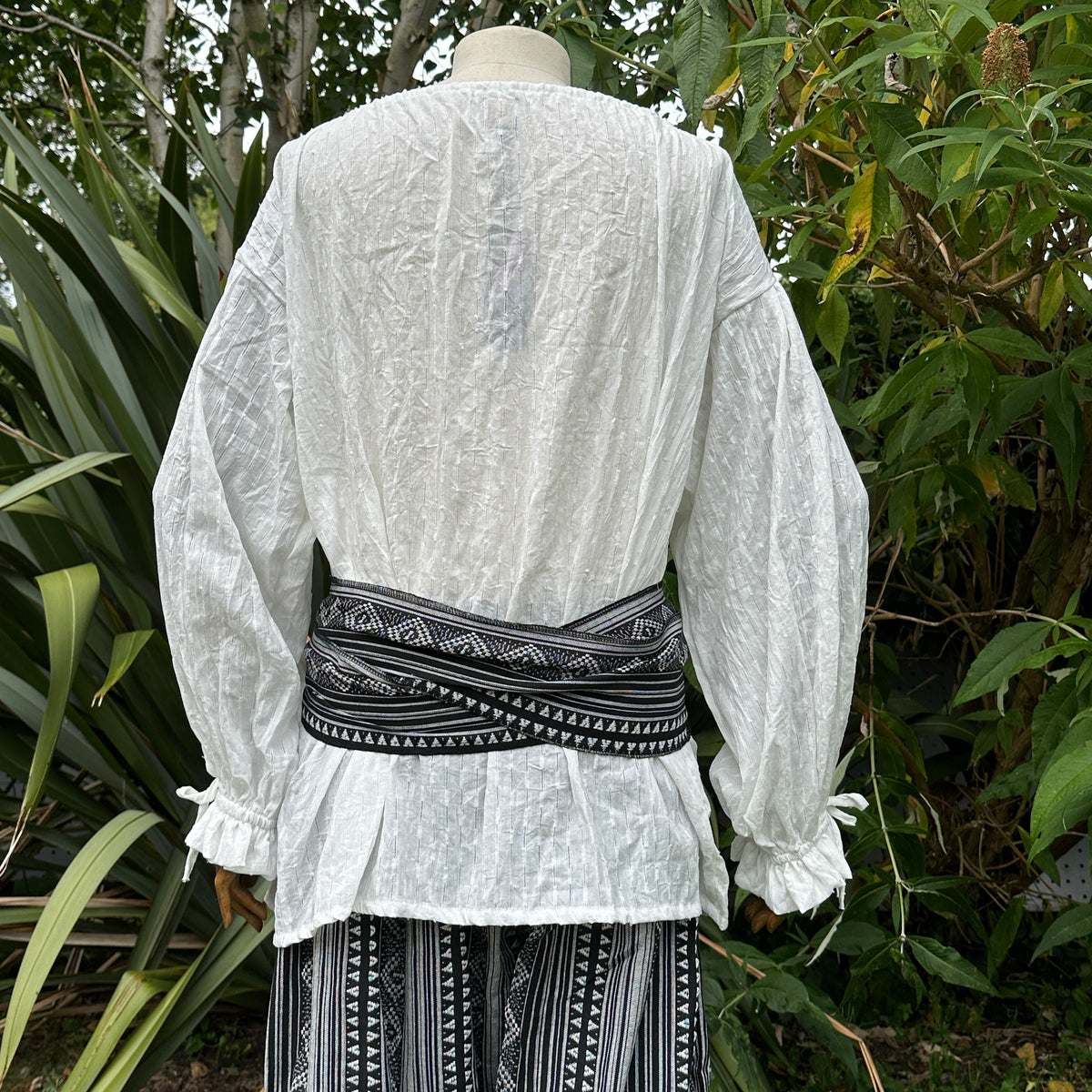 Black and white pirate sash with geometric patterns for LARP costume. Back view.