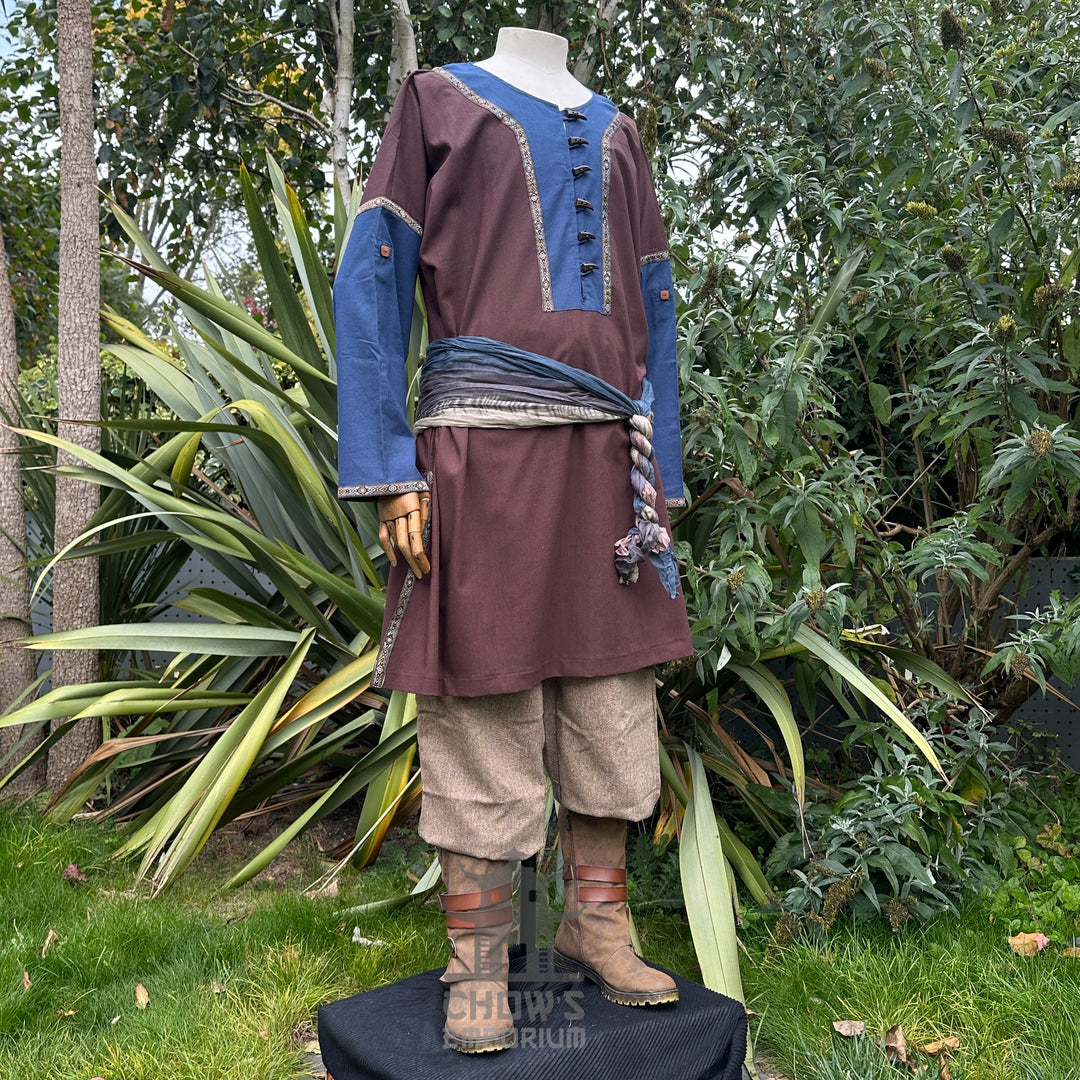 LARP medieval outfit with brown tunic, blue panels, trousers, and a sash.