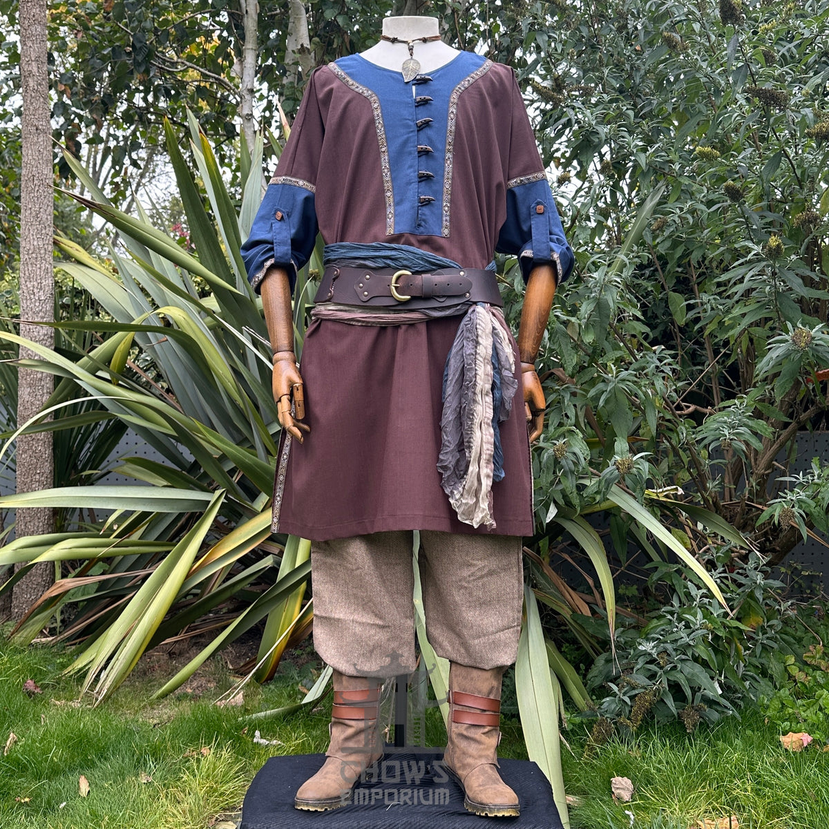 Medieval LARP outfit with blue-trimmed tunic, brown sash.