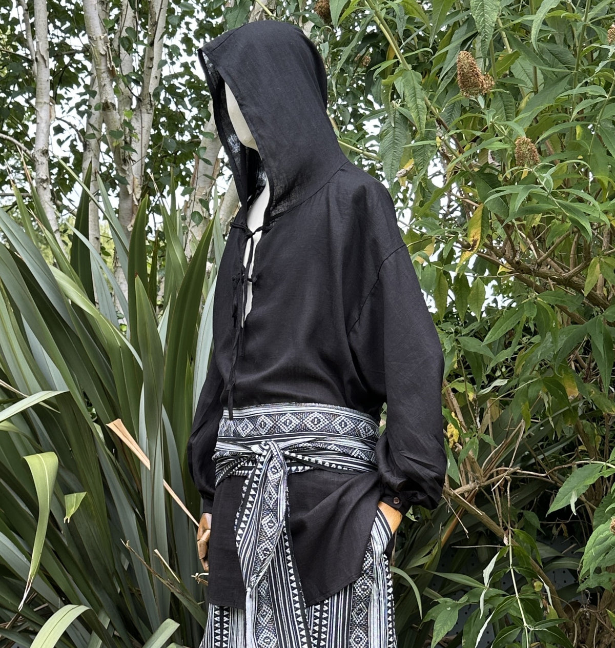 Black hooded LARP shirt with patterned belt.