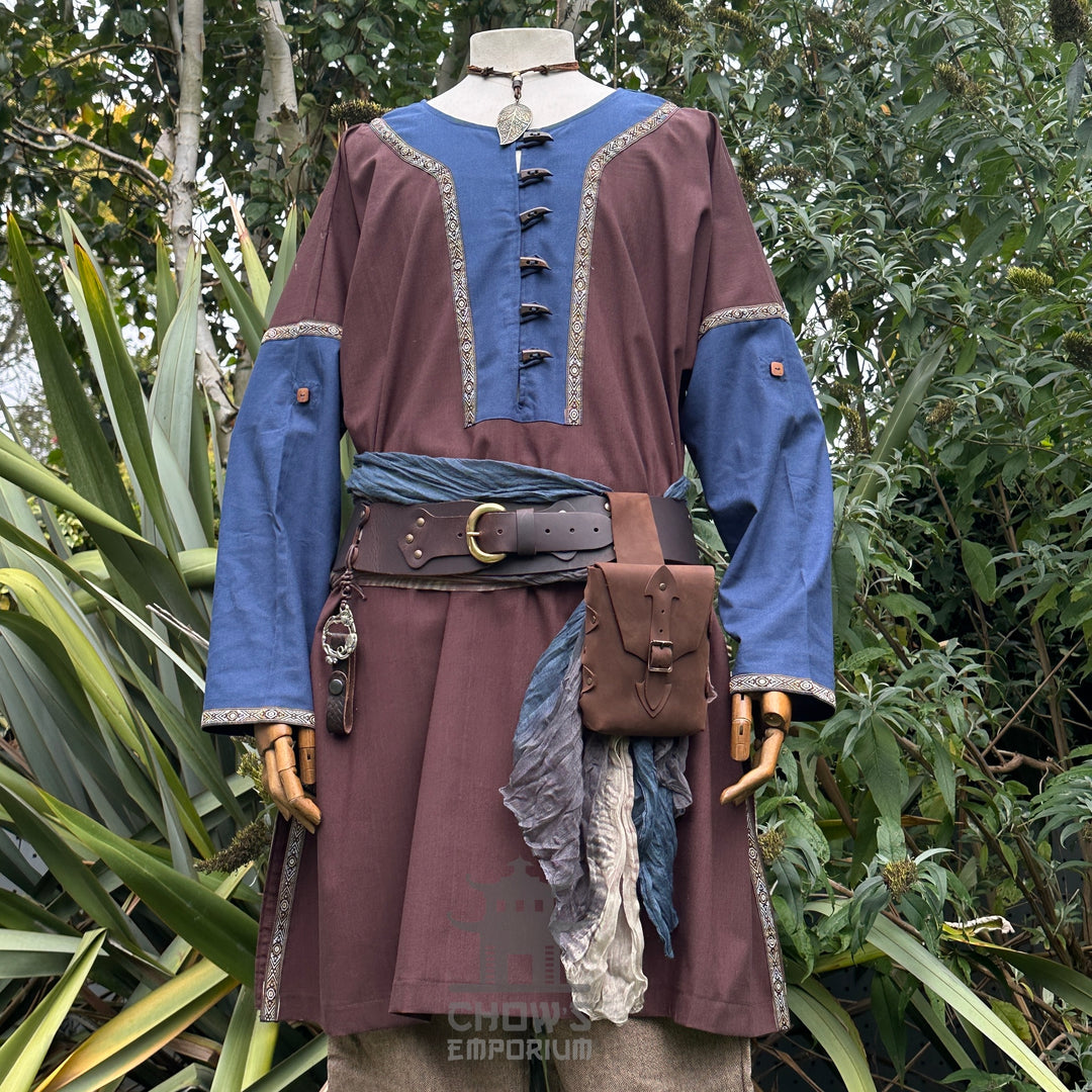 Rustic medieval LARP outfit with blue accents, forest backdrop.