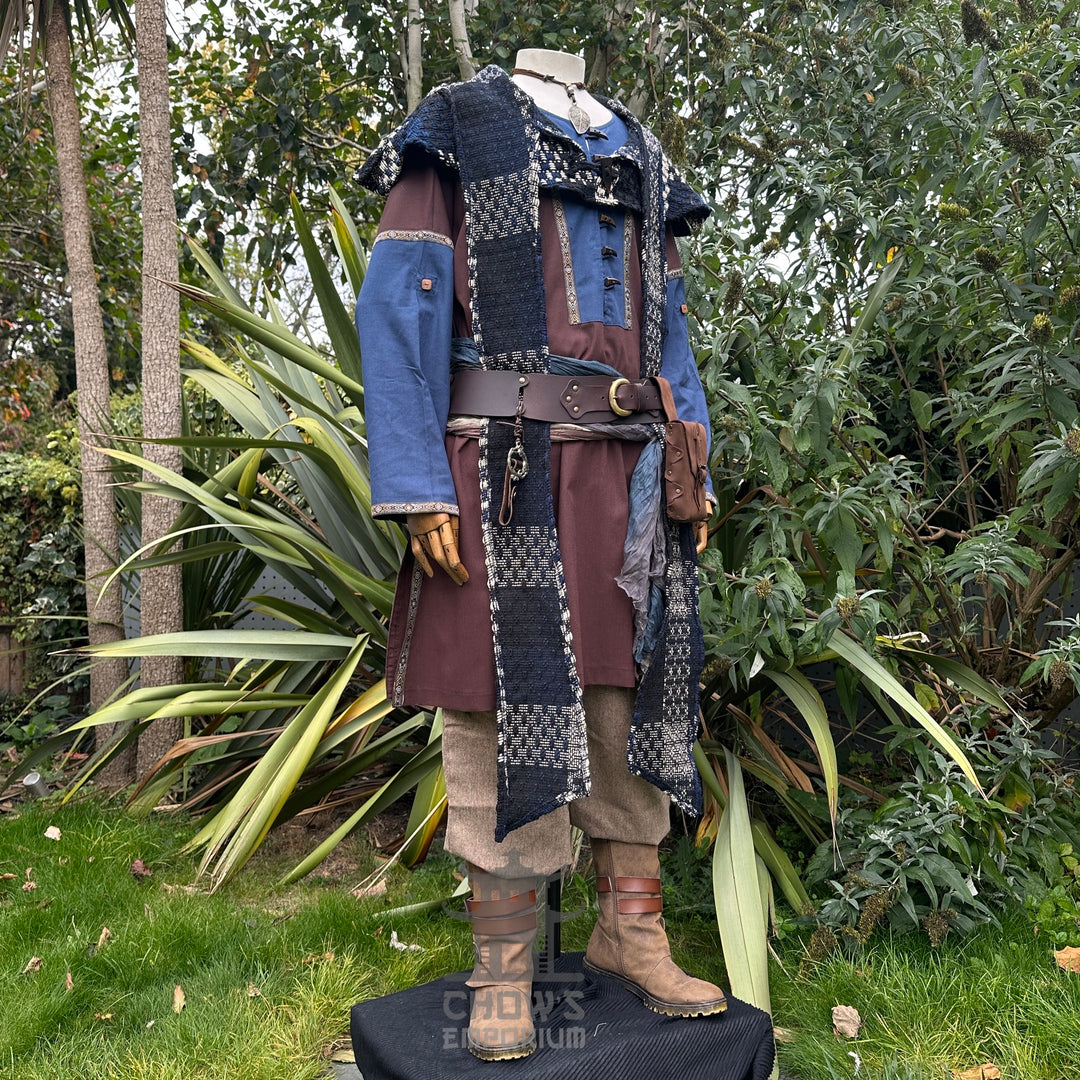 Medieval LARP outfit side view, featuring a brown and blue tunic, hood, trousers, and sash.